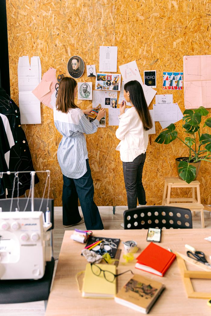 gallery-3 Two fashion designers in studio brainstorming creative ideas.